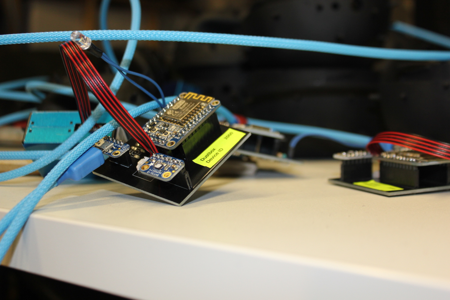 A view of fully-made-up Dustbox 2.0 PCBs with power cables twisting around