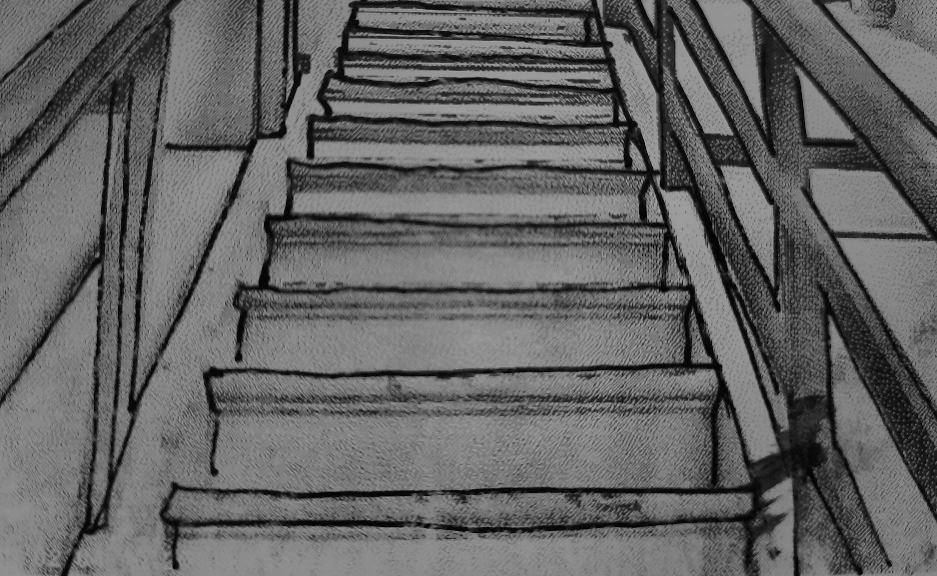 Staircase photographed from below looking upwards, showing handrails on both sides of the stairs